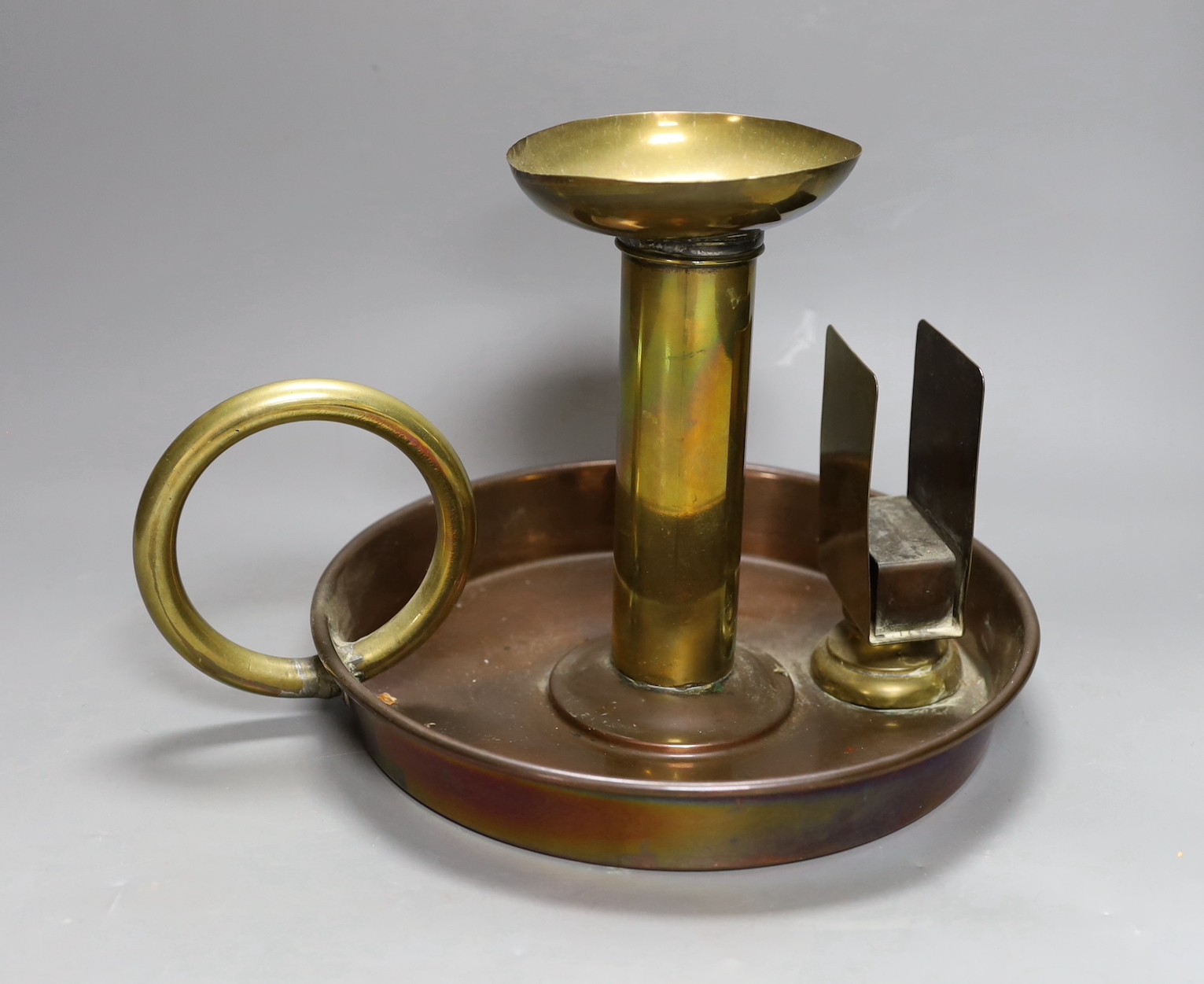 A large brass and copper chamberstick by G Farris, London, 20cm